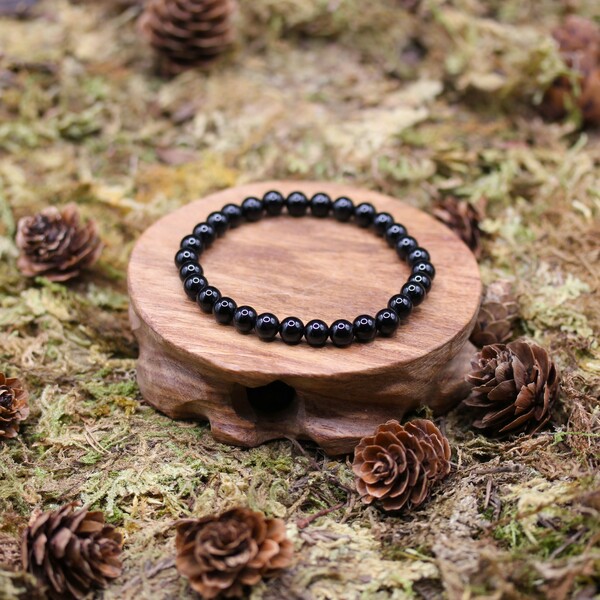 L'onyx noir est une pierre précieuse reconnue pour sa couleur noire profonde et ses vertus protectrices. Utilisée depuis l’Antiquité, elle était souvent portée comme amulette afin de repousser les énergies négatives et protéger son porteur. Cette pierre est particulièrement appréciée en lithothérapie pour ses propriétés de purification et d'ancrage. Elle aide à apporter stabilité émotionnelle et force intérieure, offrant ainsi une protection énergétique de grande puissance.